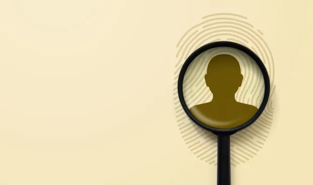Illustration of a magnifying glass highlighting a human silhouette against a fingerprint background. Represents identity search, biometric verification, or forensic investigation.